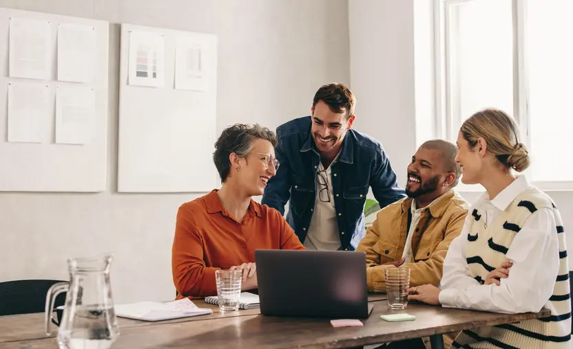 Colleagues laughing in a meeting