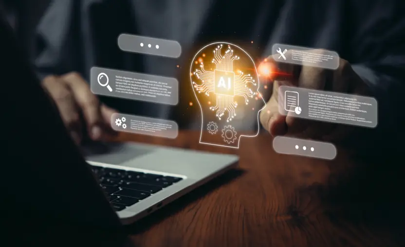 A man presses a holographic outline of a head representing AI while he works on a computer