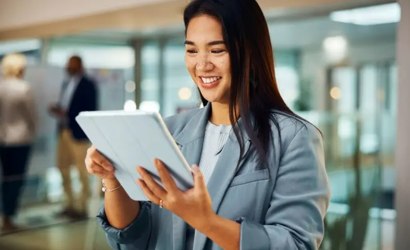 Corporate businesswoman with tablet in office for research