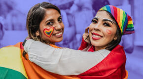 Two people participating in a Pride celebration