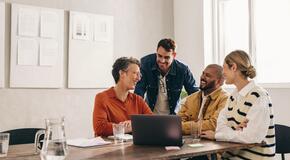 Colleagues laughing in a meeting