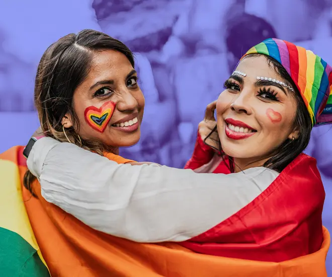 Two people participating in a Pride celebration