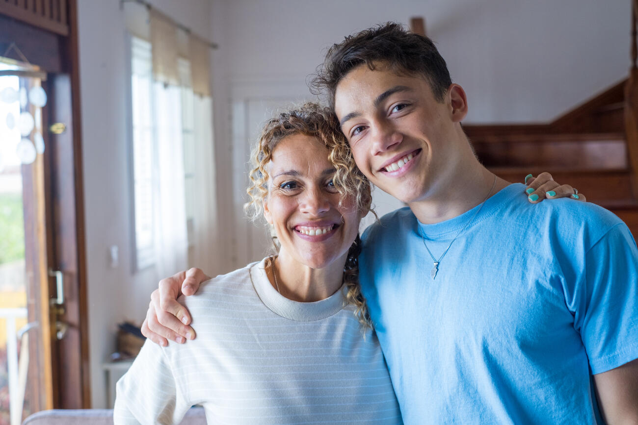 boy hugging woman for giving day 