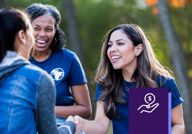 Female volunteer shaking hands with another woman