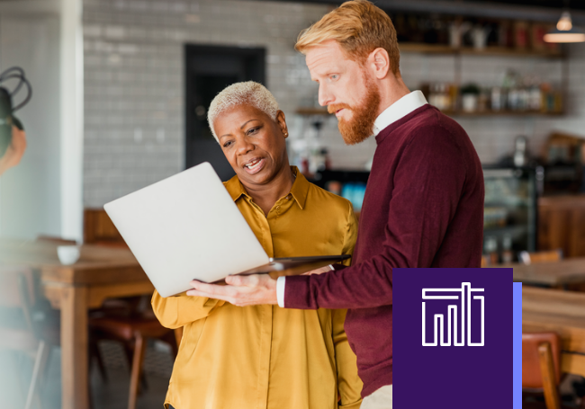 man and woman standing with laptop computer