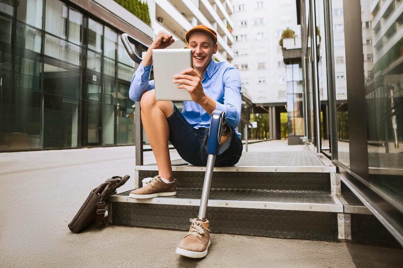 Man sits outside looking at table