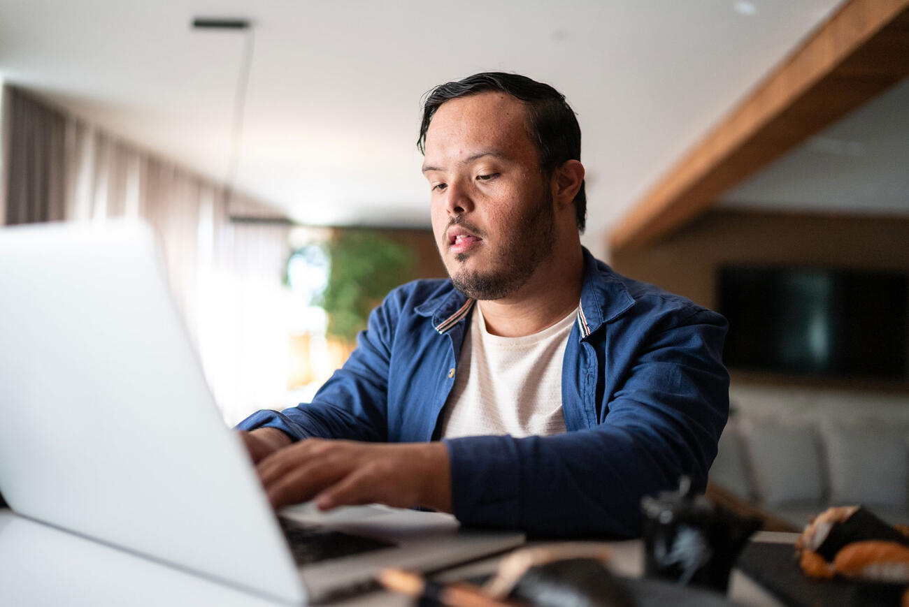 Man works on his laptop from home