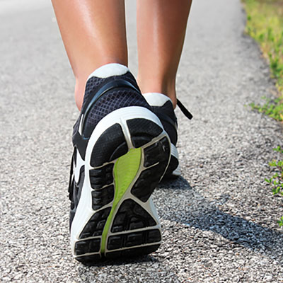 This close-up photo of someone wearing running shoes represents 5K runs and walks, which are fundraising event ideas that often have a high ROI.