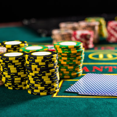 This photo of poker chips on a card table demonstrates the college and university fundraising event idea of a casino night.