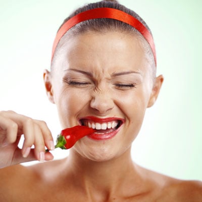 This photo of someone eating a hot pepper demonstrates one possibility for the budget-friendly fundraising event idea of dollars for dares.