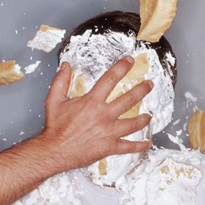 This photo of someone getting a pie in the face demonstrates one possibility for a workplace leadership challenge as a fundraising event idea.