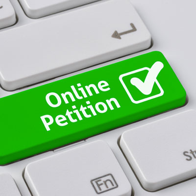 This photo of a green button with a check mark reading “online petition” shows a popular online fundraising event idea.