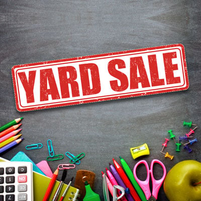 This photo of miscellaneous school supplies with a yard sale sign shows how well a yard sale can work as a school fundraising event idea.