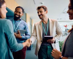 A photo of people at a charity event shaking hands with donors.