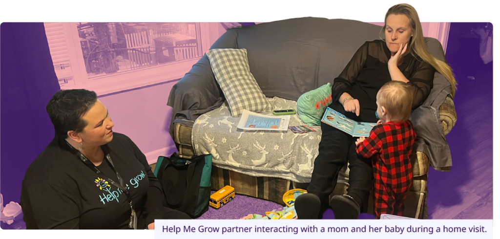 Help Me Grow partner interacting with a mom and her baby during a home visit.