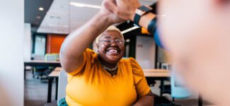 Coworkers celebrate a win with a high five