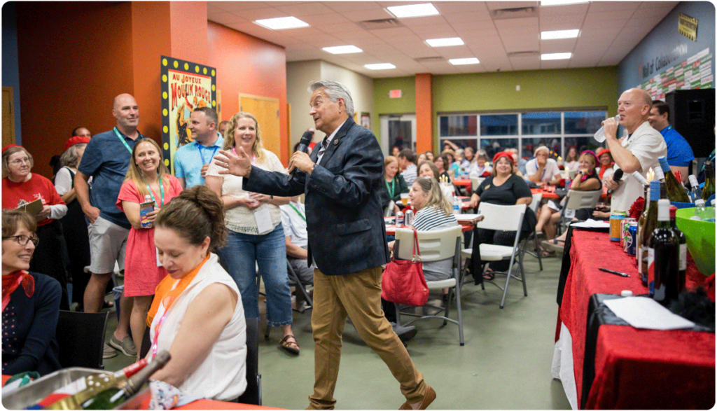 Attendees interacting with auctioneer at June-a-Palooza