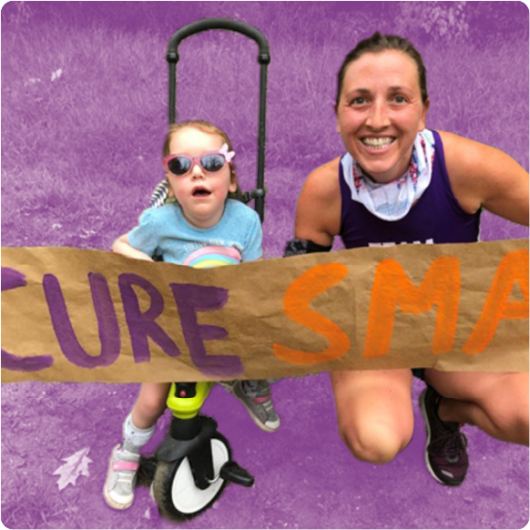 A family holds a "Cure SMA" banner at a walk-a-thon