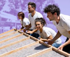 A team of employees volunteer to build a home.