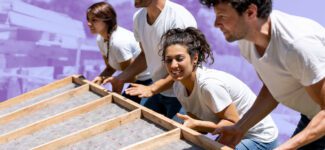 A team of employees volunteer to build a home.