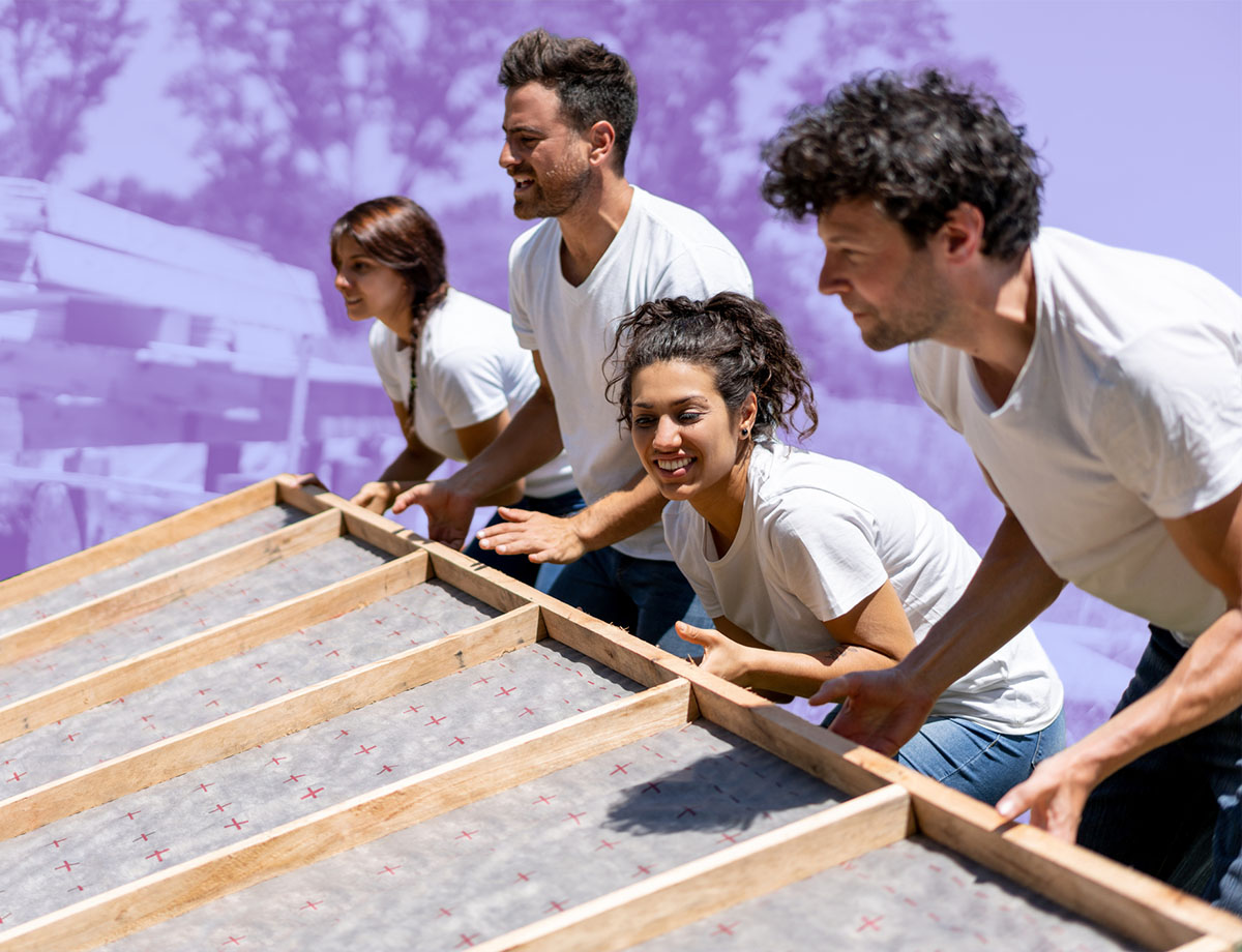 A team of employees volunteer to build a home.