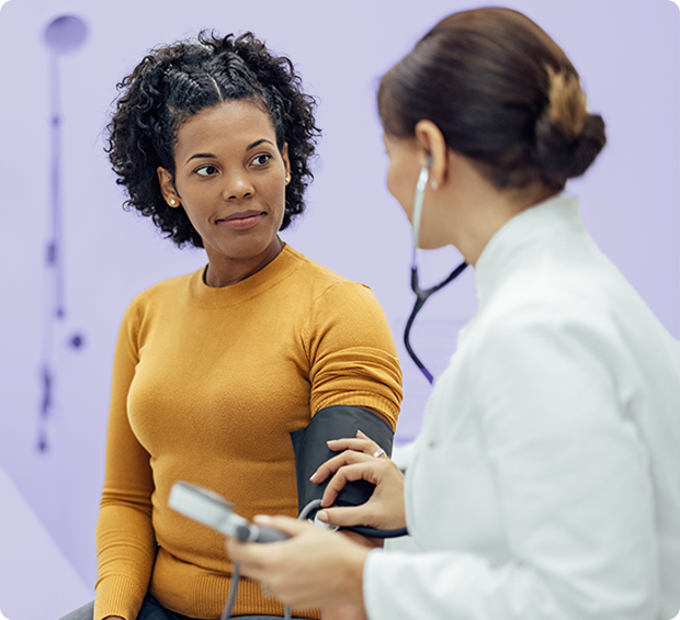 A doctor checks a patient's blood pressure.