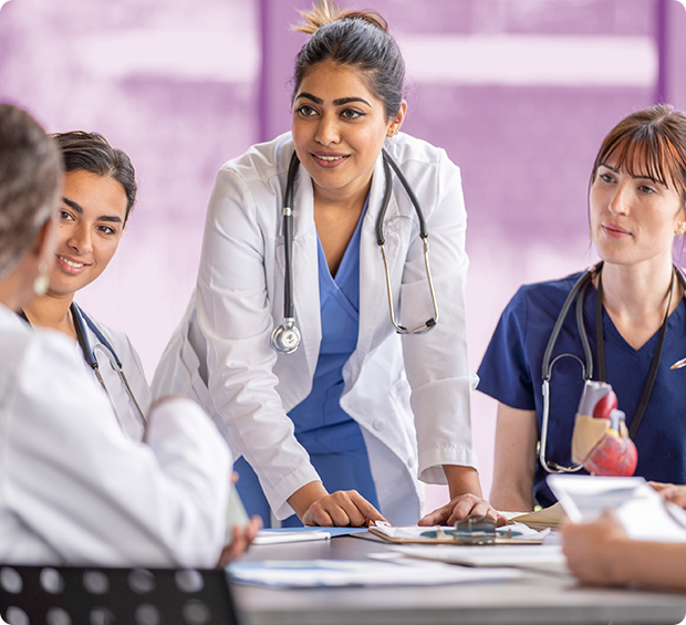 Medical professionals having a discussion at a table.