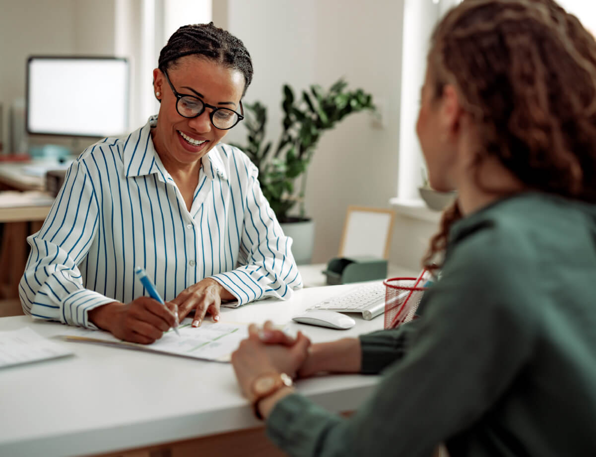 A photo of nonprofit case management, where two people are sitting down for a meeting.