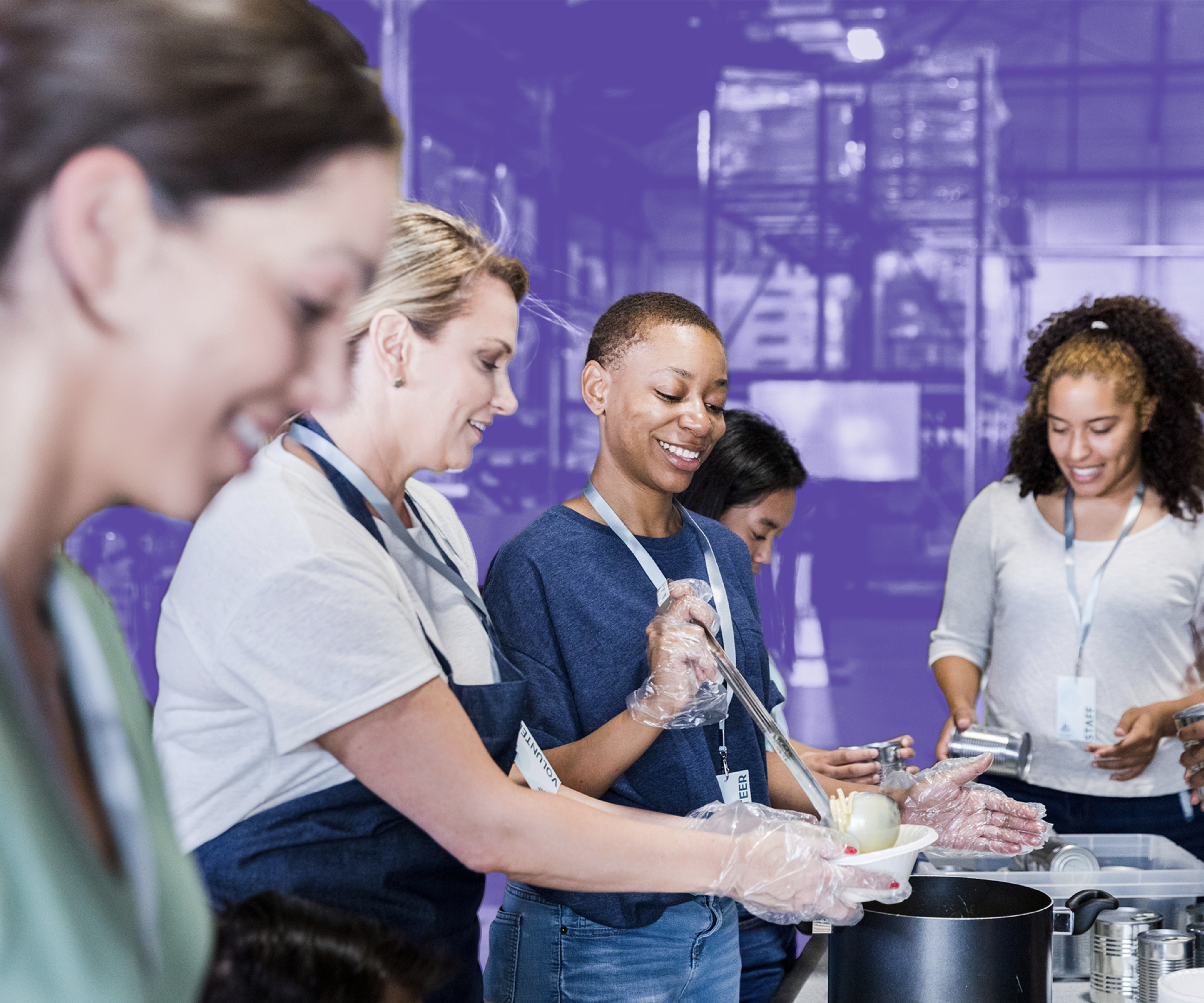 Group of workers preparing food for residents experiencing homelessness and poverty.