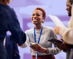 A photo of two people shaking hands at a networking event.